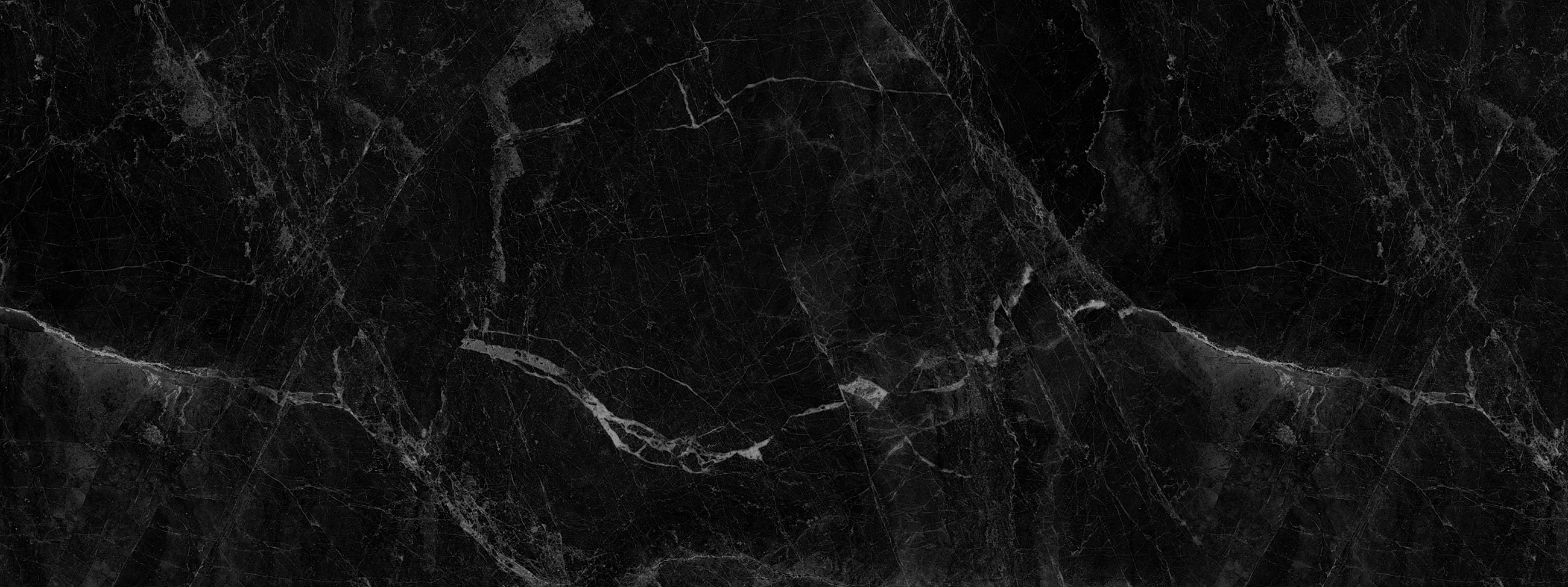 Textured black marble stone background with white veining.