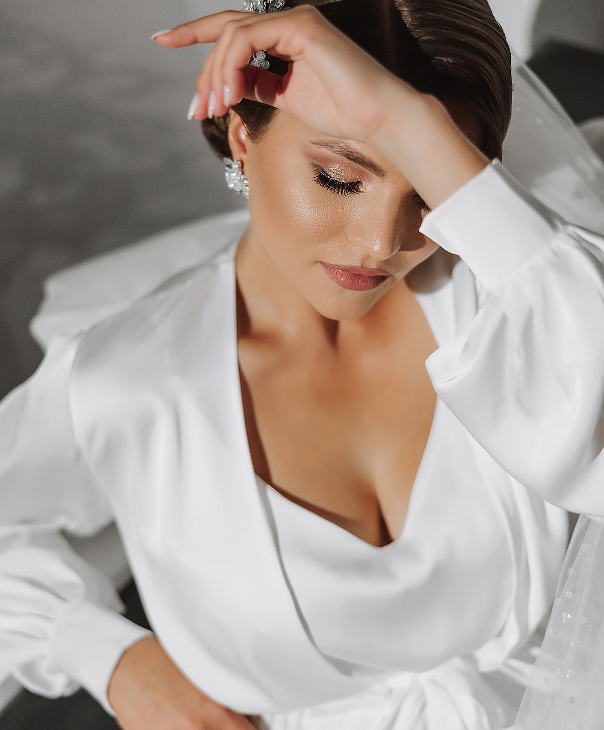 Bridal portrait with elegant white dress and accessories.