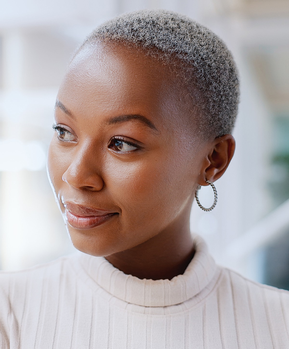 Woman with short gray hair and sweater.