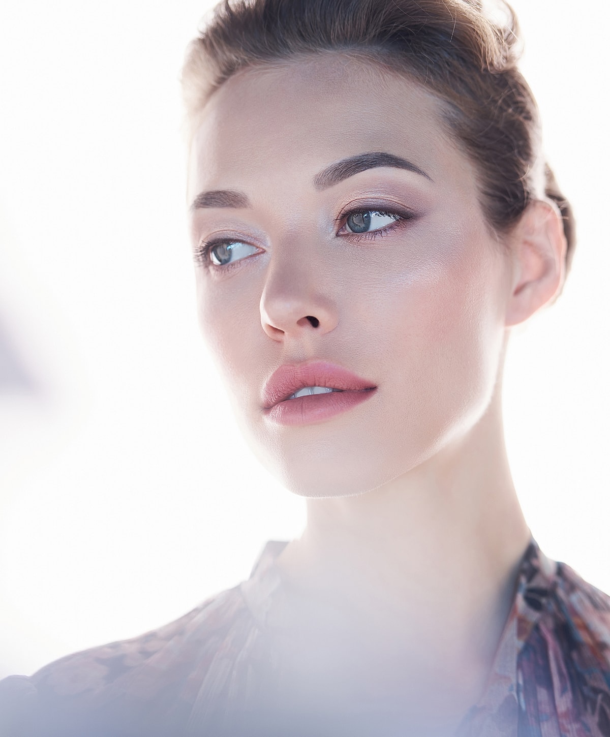 Close-up of a woman's face with natural makeup.