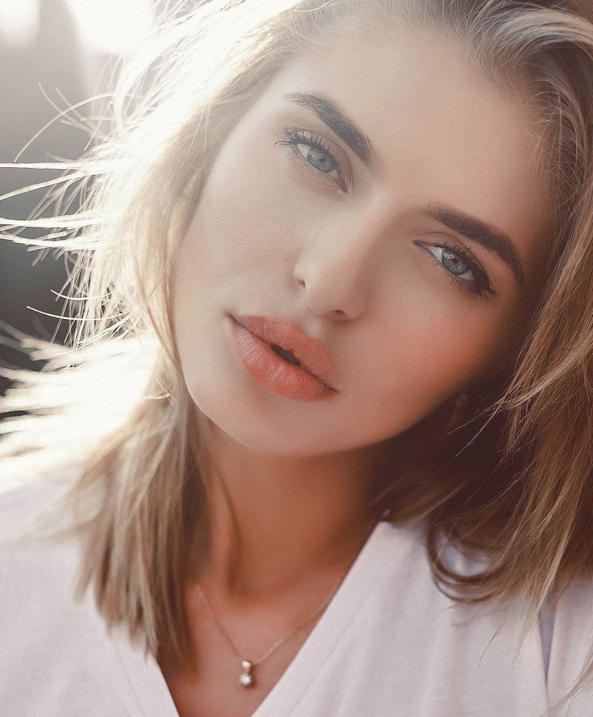 Woman with natural makeup and soft lighting.