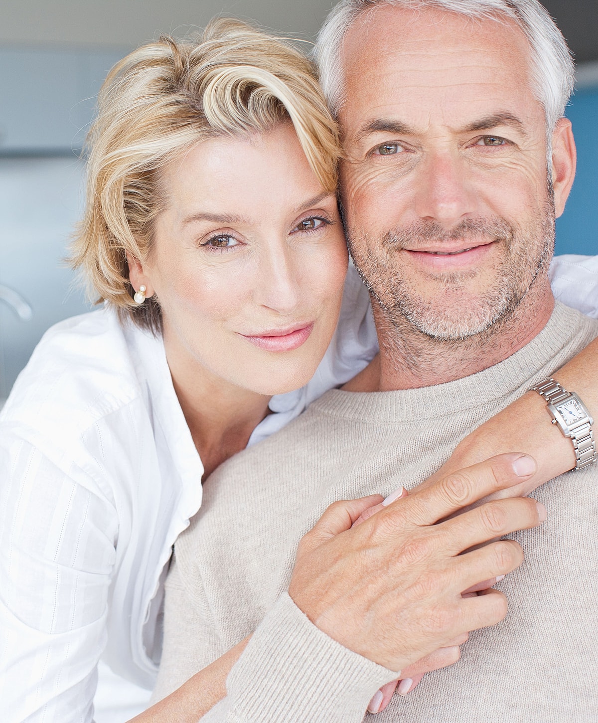 Couple embracing and smiling together.
