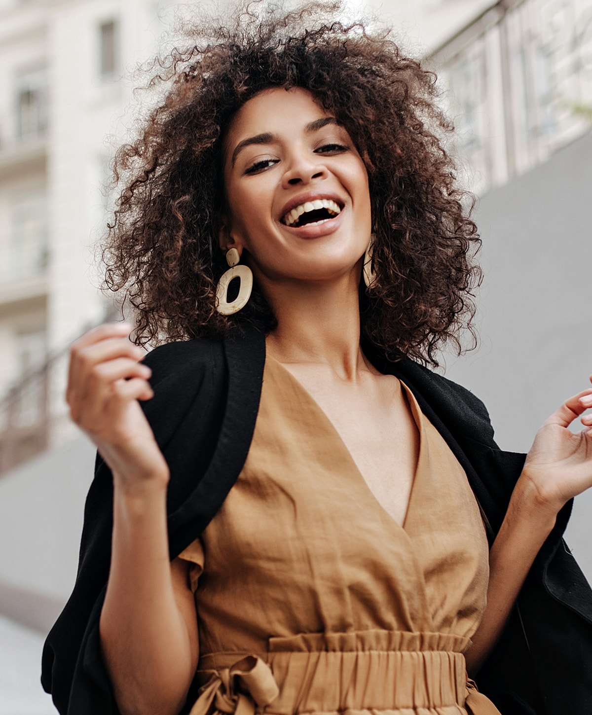 Smiling woman in stylish outfit outdoors.
