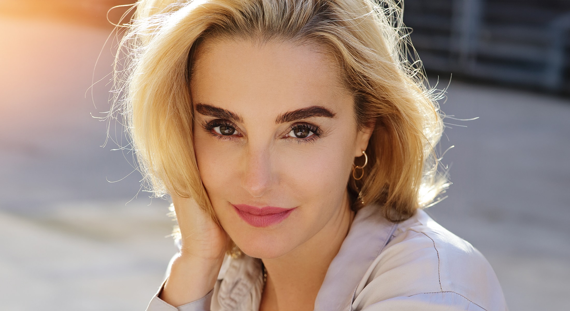 Woman with blonde hair, natural light portrait.